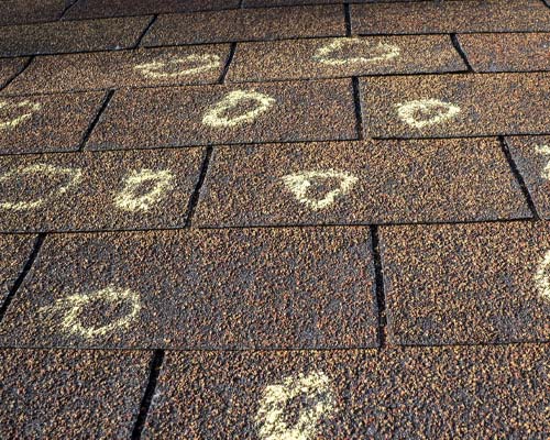 hail damaged shingles with markers