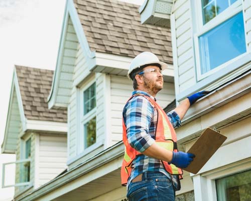 Tech inspecting roof