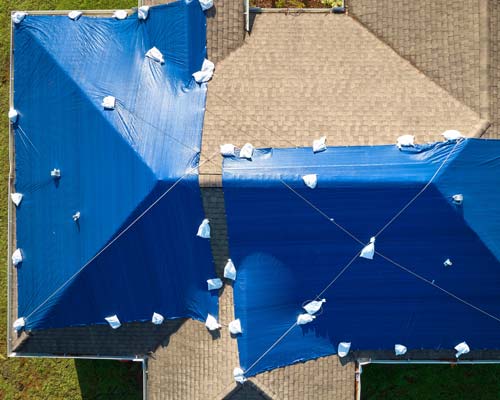 Blue tarps on roof - aerial view